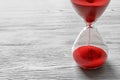 Hourglass with flowing red sand Royalty Free Stock Photo