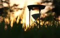 Hourglass in the grass time during sunset. vintage style.