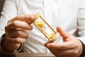 Hourglass in the hands of a businessman in a white shirt. Planning time and reducing business costs. Catch all and do all planned Royalty Free Stock Photo