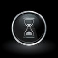 Hourglass icon inside round silver and black emblem