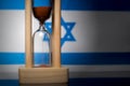 Hourglass and Israel flag, soft focus, copy space