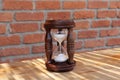 An hourglass made of brown wood.