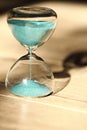 An hourglass measuring the passing time in a countdown to a deadline Royalty Free Stock Photo