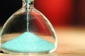 An hourglass measuring the passing time in a countdown to a deadline Royalty Free Stock Photo