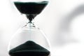 An hourglass measuring the passing time in a countdown to a deadline Royalty Free Stock Photo