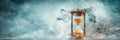 Hourglass measuring time while dissolving into smoke and clouds Royalty Free Stock Photo