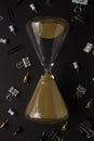 Hourglass with office accessories. Business, work. Black style, concept of running out of time Royalty Free Stock Photo