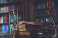 Hourglass and Old quill pen, hourglass, books and vintage inkwell on wooden desk