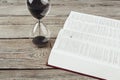 Hourglass and open bible. top view. creative photo. Royalty Free Stock Photo