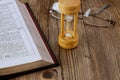 Hourglass and open Bible symbolizing the end times according to the Holy Bible Royalty Free Stock Photo