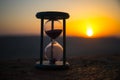 Hourglass Passing of Time Lapse Clouds. An hourglass in front of a bright blue sky with puffy white clouds passing. Time concept.