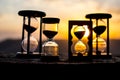 Hourglass Passing of Time Lapse Clouds. An hourglass in front of a bright blue sky with puffy white clouds passing. Time concept.