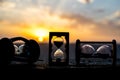 Hourglass Passing of Time Lapse Clouds. An hourglass in front of a bright blue sky with puffy white clouds passing. Time concept. Royalty Free Stock Photo