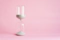 Hourglass on pink background