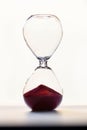 Hourglass with red sand and backlight Royalty Free Stock Photo