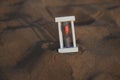 Hourglass on a sand dune beach Royalty Free Stock Photo