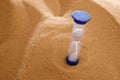 Hourglass on a sand dune beach. concept passage of time Royalty Free Stock Photo