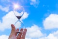 Hourglass Sand Timer Clock time blue sky cloud background Royalty Free Stock Photo