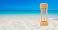 Hourglass set on a white sand background sea background, time concept Royalty Free Stock Photo