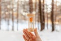 Hourglass in the snow. Spring is coming. melting snow Royalty Free Stock Photo