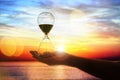 Hourglass at sunset concept for time passing