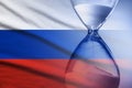 Hourglass superimposed over a Russian flag, deadline