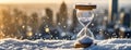 Hourglass in winter snow background. Concept of approaching Christmas and New Year holidays. Symbol of changing of the Royalty Free Stock Photo