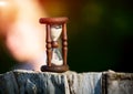 Hourglass on woden stump Royalty Free Stock Photo