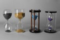 Hourglasses on grey background. Time management concept Royalty Free Stock Photo