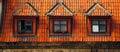 House with amber tiles, three windows, brick fixtures