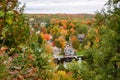 House amon colourful trees in a forested landscape in autumn