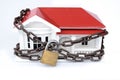 House arrest: locked down or quarantined concept of model home with chain and lock Royalty Free Stock Photo