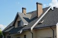 House asphalt shingles rooftop with dormer window, attic skylights, rain gutter, soffits, roof vents Royalty Free Stock Photo