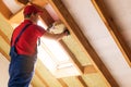 House attic insulation - construction worker installing wool Royalty Free Stock Photo