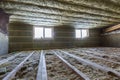 House attic under construction. Mansard walls and ceiling insulation with rock wool. Fiberglass insulation material in wooden fram