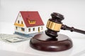 House auction concept. Gavel in front of model of house Royalty Free Stock Photo