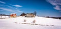 House and barn on snow covered farm fields in rural Carroll County, Maryland. Royalty Free Stock Photo