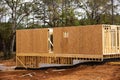 House with basement and slab foundation, retaining concrete wall under construction, timber frame post, beam and OSB Royalty Free Stock Photo