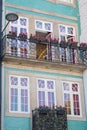 House with blue tiles and balcony with flowers. Traditional exterior of building in Porto, Portugal. Royalty Free Stock Photo