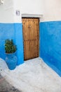 House with blue walls and wooden door