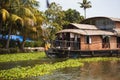 House-boat pleasure cruise ship in India  Kerala on the seaweed-covered river channels of Allapuzha in India. Boat on the lake in Royalty Free Stock Photo