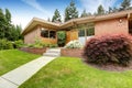 House with brick trim. Entrance porch and front yard view