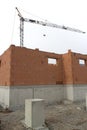 House building construction site with brick walls and a building crane Royalty Free Stock Photo