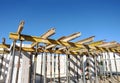 House building: Shell of a new house with ceiling supports at a site under a blue sky Royalty Free Stock Photo
