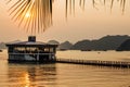 House building on the water against the background of the mountains at sunset, palm branch path to the beach Royalty Free Stock Photo