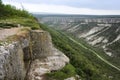 House built in a cave on a high cliff above the mountain valley in the famous ancient city-fortress of Chufut-Kale Royalty Free Stock Photo