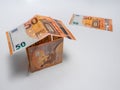 House built with fifty euro bills on a white background Royalty Free Stock Photo