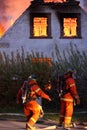 House burning and fire fighters Royalty Free Stock Photo
