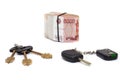 House and car key with pile of rolled cash money white background Royalty Free Stock Photo