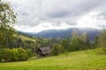 House.Carpathians.Blue clouds green glade Royalty Free Stock Photo